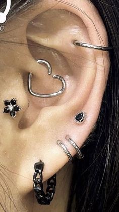 an ear with three different piercings attached to it