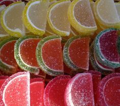 many different colored slices of fruit on display