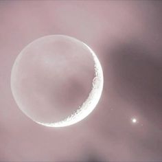 an image of a moon in the sky with some clouds around it and two stars