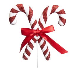 two candy canes wrapped in red and white paper with a bow on top, isolated against a white background