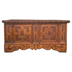 an old wooden sideboard with carvings on the front and sides, isolated against a white background