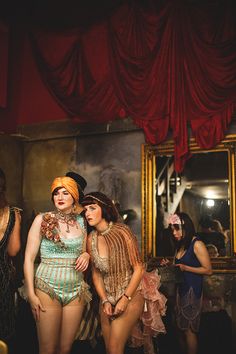 three women in costumes standing next to each other