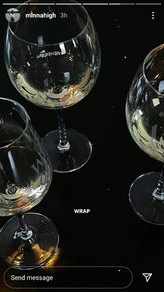 three wine glasses sitting next to each other on top of a black surface with words below them