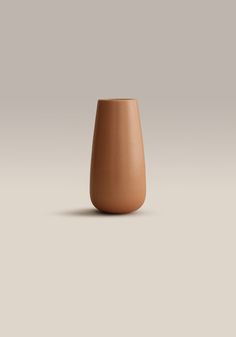 a brown vase sitting on top of a table