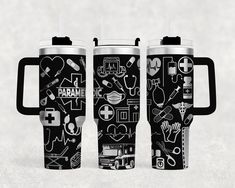 two black and white travel mugs with medical symbols on them