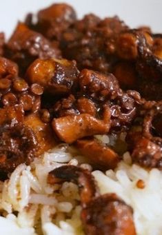 a close up of rice and meat on a plate