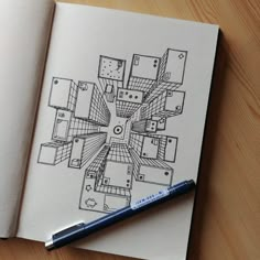 a pen is sitting on top of an open notebook with a drawing of a house