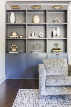 a living room filled with furniture and lots of shelves