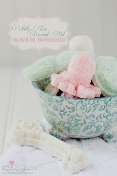 a bowl filled with marshmallows on top of a white towel next to a spoon