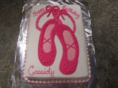 a birthday cake with pink shoes on it