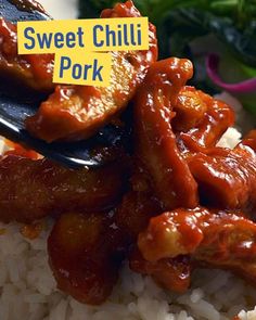 a spoon with some food on top of it and a sign that says sweet chilli pork