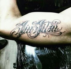 a man with a tattoo on his arm that says, airbrushe in cursive writing