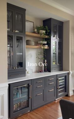 an empty kitchen with gray cabinets and white counter tops is pictured in this image, the words iron ore above the cabinet doors