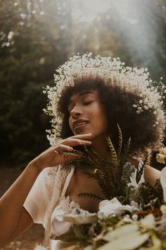 a woman with flowers in her hair sitting at a table