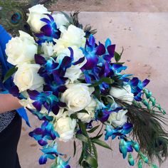 a bridal bouquet with blue and white flowers