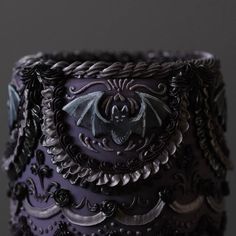 an elaborately decorated purple cake with black icing