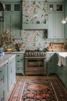 a kitchen with blue cabinets and an area rug on the floor in front of the stove