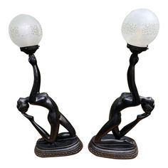 a pair of art deco table lamps with glass globes