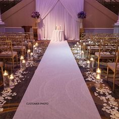 the aisle is decorated with candles and flowers