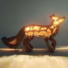 a paper cut out of a fox with glowing eyes and tail, standing on the ground