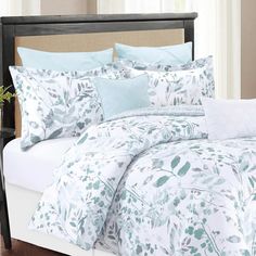 a bed with blue and white comforters in a bedroom