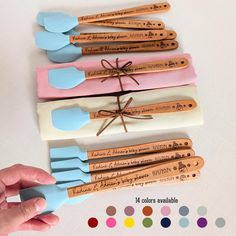 five wooden utensils with different colors and designs