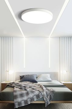 a modern bedroom with white walls and wood flooring