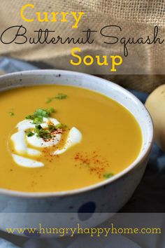 a white bowl filled with soup and topped with soury butternut squash, garnished with parsley