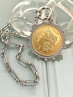 Beautiful reproduction vintage Gold coin pendant, Morgan Peace Dollar coin in a silver bezel with cubic zirconia stones. The bale attached to the coin is also encrusted with CZ stones. The coin is 22k gold plated and elegantly hangs from a multi link Rhodium plated brass chain and a spring lock CZ clasp The spring lock closure not only makes it easy to open and close the necklace for those with difficulty but adds to the creativity of the jewelry piece. Will enhance any outfit. Jeans to the litt Roman Coin Jewelry, Gold Coin Jewelry, Coin Jewellery, Gold Coin Pendant, Chunky Gold Necklaces, Silver Coin Necklace, Gold Snake Chain, Peace Dollar, Gold Chain Choker