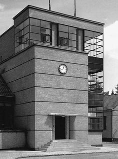 a black and white photo of a building with a clock