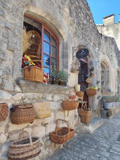 an old stone building with baskets on the outside