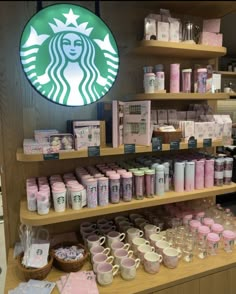 a starbucks coffee shop display with cups and mugs