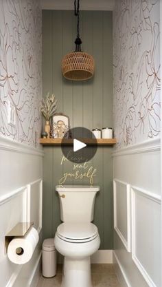 a white toilet sitting inside of a bathroom next to a wooden shelf filled with items