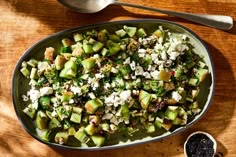 a salad with cucumbers, feta cheese and black pepper