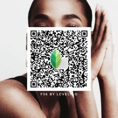 a woman holding up a qr code with a green leaf on it's face