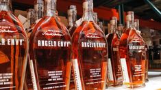 several bottles of alcohol are lined up on a shelf