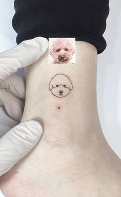 a small dog's face is shown on the side of a woman's ankle