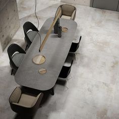 a long table with chairs around it in an empty room that has no people inside