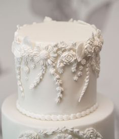 two tiered wedding cake decorated with white flowers