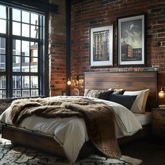 Chic industrial bedroom featuring a red brick wall, wooden headboard, and vintage metal side tables. The room showcases a cozy fur blanket on a plush bed, black window frames with cityscape views, and warm lighting from industrial pendant lights. Artistic touches include vintage posters and modern art frames, enhancing the urban vibe on dark wood flooring. Bedroom With Brick Wall, Dark Wood Flooring, Brick Wall Bedroom, Metal Side Tables, Cozy Small Bedrooms, Black Window Frames, Apartment Styles