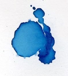 a blue ink stain on white paper