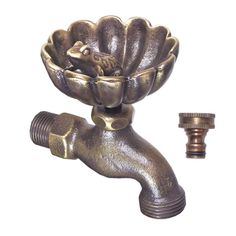 a metal sink faucet with a flower shaped bowl on it's side