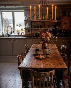 a wooden table sitting in the middle of a kitchen