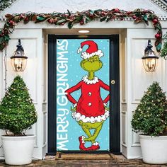 the grinch door cover is decorated with potted plants and christmas wreaths on either side