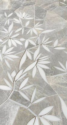 an artistic tile design with white leaves on grey and gray ground, in the shape of a flower