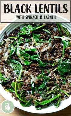 black lentils with spinach and lamb meat in a white bowl on a wooden table