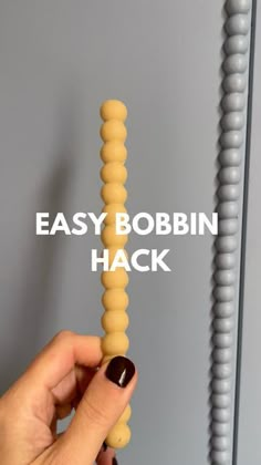 a hand holding an object with the words easy bobbin hack