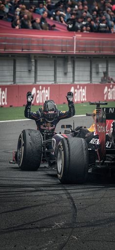 two red bull racing cars on a race track