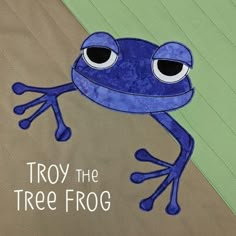 a blue frog with the words troy the tree frog on it's back side