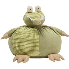 a stuffed animal sitting on top of a green pillow with two eyes and one nose